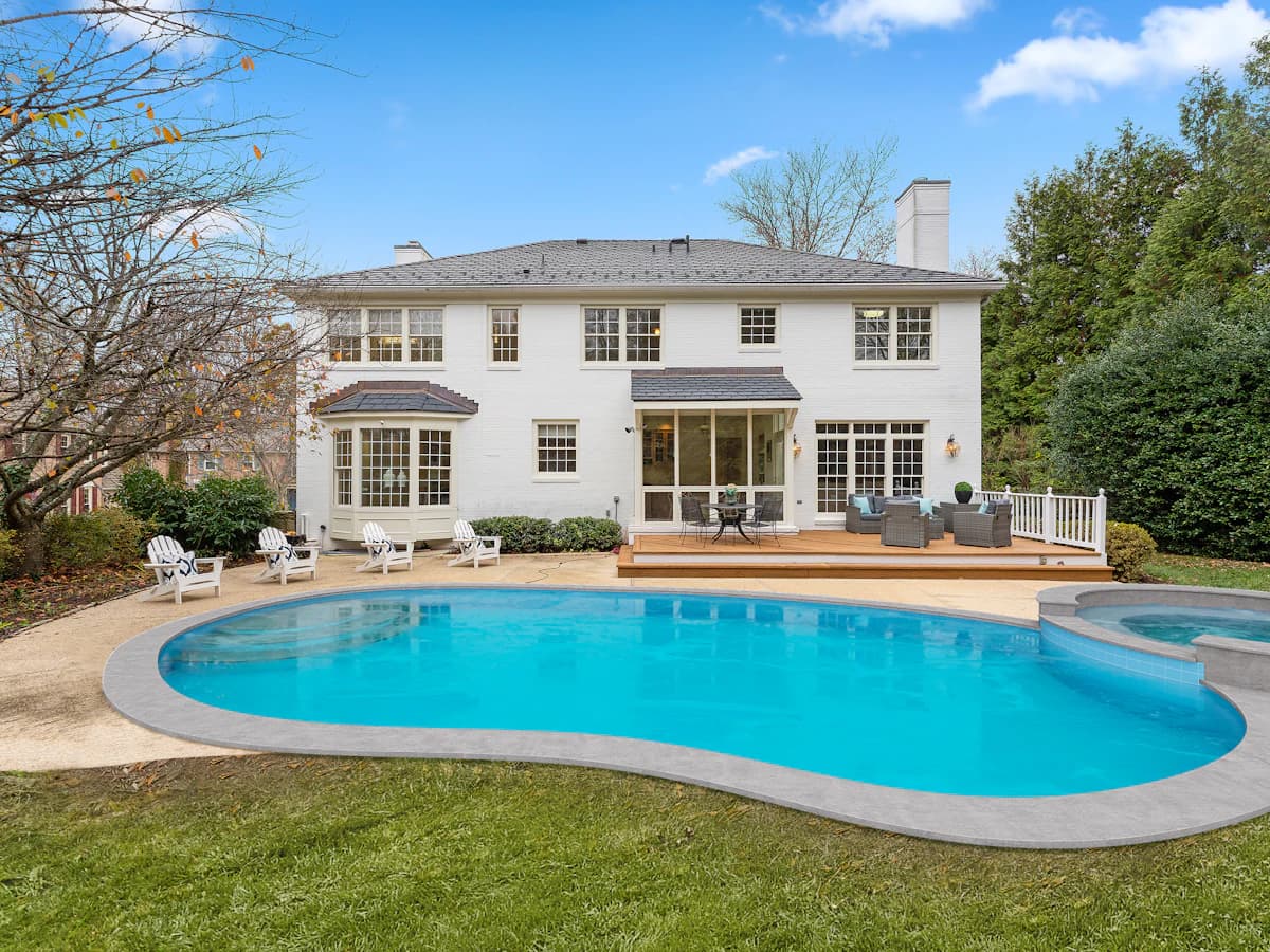 A backyard swimming pool and its paved surround